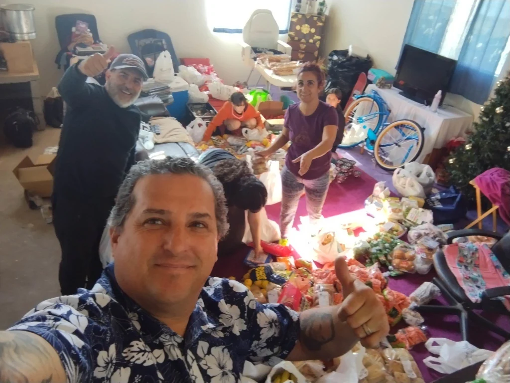 Jason with his family and Jose preparing food and gift donations to be given out.