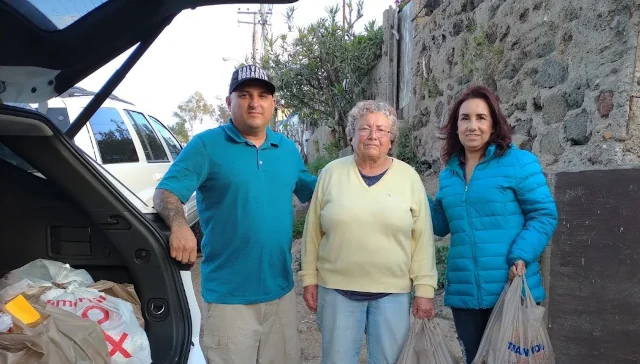 Jason and Nancy Toscano with an elderly lady that they helped.
